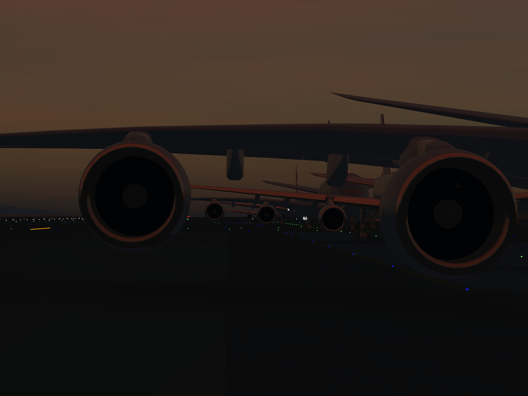 A row of large jet airplanes is seen from a low angle at dusk, highlighting their engines and wings against a dimly lit runway.
